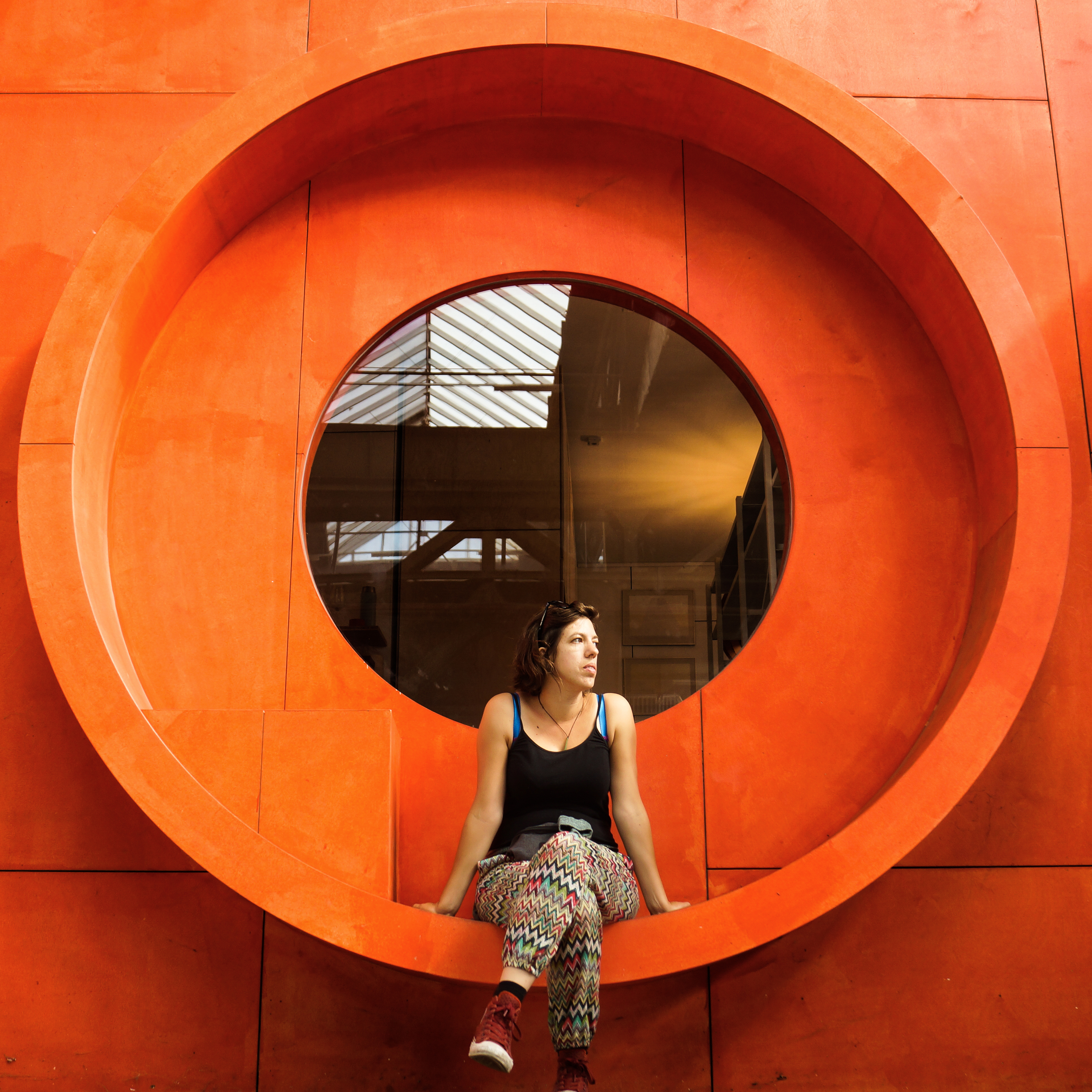 A woman sitting in a orange circle