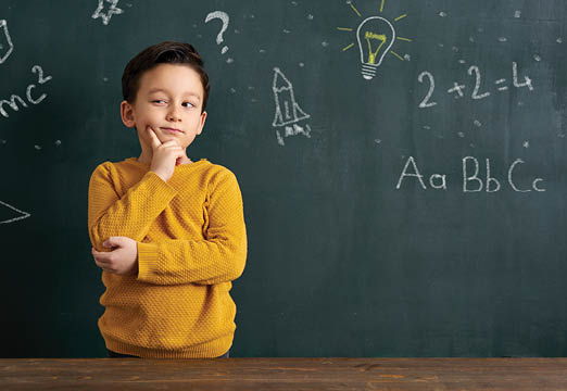 A child thinking with math problems around them.